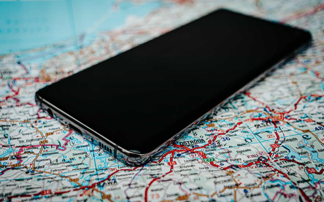 Smartphone sobre un mapa representando el uso de datos móviles y geolocalización durante el confinamiento en Austria por la COVID-19.